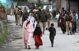 Kashmiri villagers move towards safer places after they evacuated their village following overnight shelling, in Uri, India-administered Kashmir